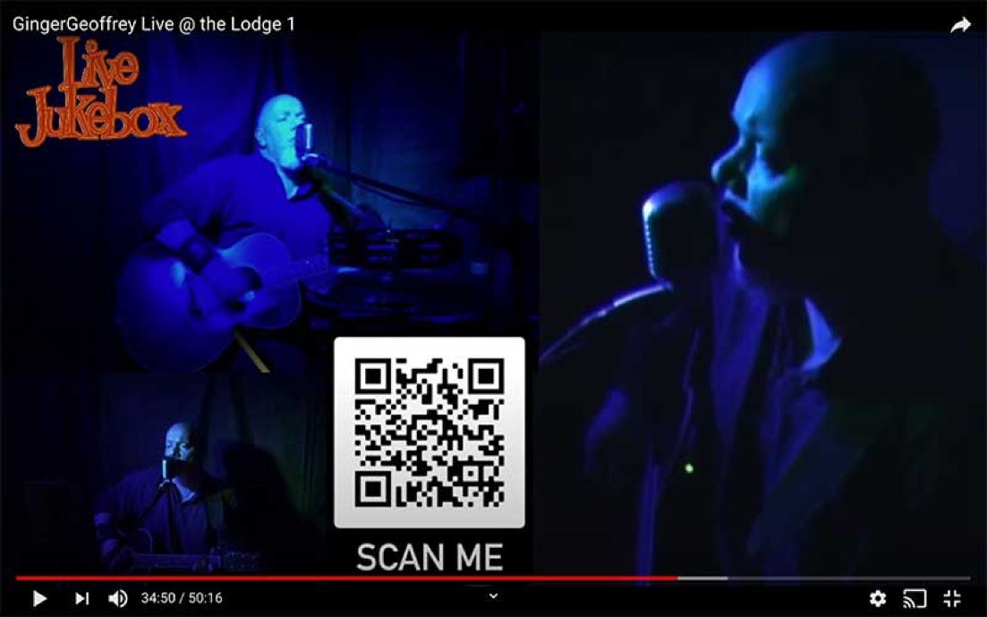 Ginger Geoffrey performing a live jukebox bathed in blue light as part of an online stream